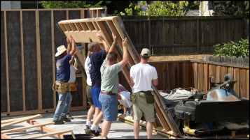 Construction Crew Standing up PMHI Pre-Framed Wall Panels. Picture Courtesy California Precut Homes